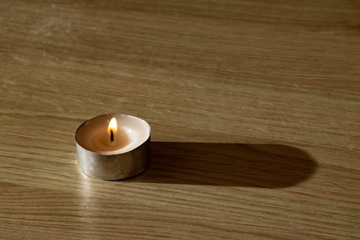 The Little candle on a wooden table with copy space