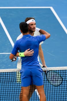 MELBOURNE, AUSTRALIA - JANUARY 11: Novak Djokovic of Serbia and Stefanos Tsitsipas of Greece play each other during a charity match ahead of the 2024 Australian Open at Melbourne Park on January 11, 2024 in Melbourne, Australia.