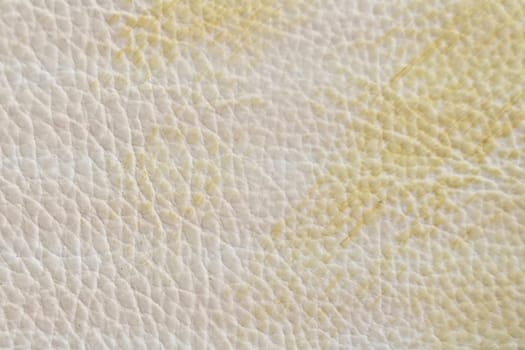 White and yellow leather texture with folds, used as a classic background. Texture and backgrounds