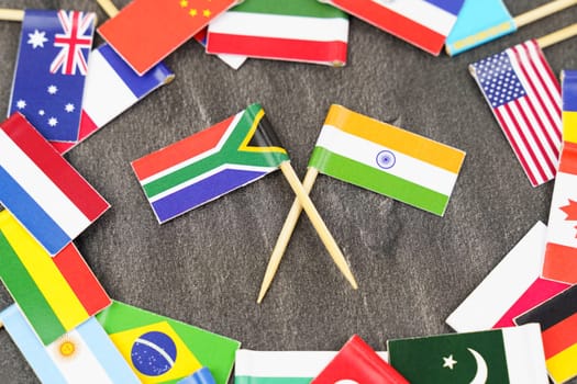 Policy. National flags of different countries. The concept is diplomacy. In the middle among the various flags are two flags - India, South Africa