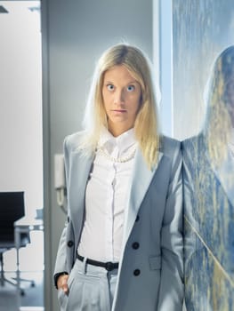 Portrait of Fashionably Dressed Pretty Business Woman Standing in Office Hall
