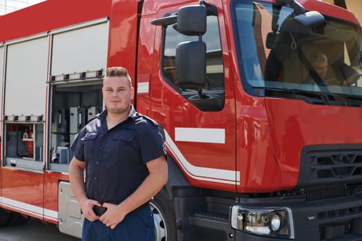 A confident firefighter strikes a pose in front of a modern firetruck, exuding pride, strength, and preparedness for emergency response.