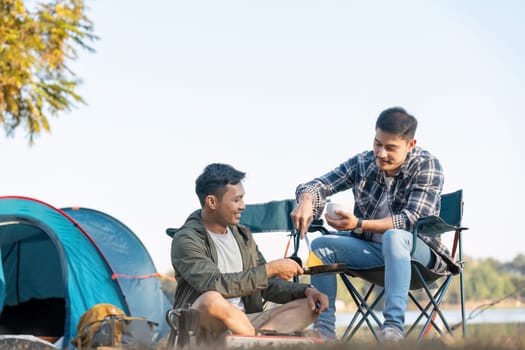 Happy Asian male gay couple on camping together in a forest. romantic vocation trip. lgbt concept.