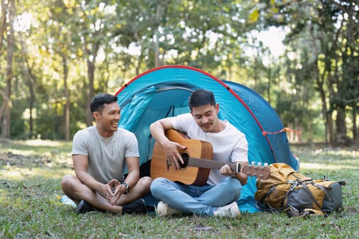 Happy Asian male gay couple on camping together in a forest. romantic vocation trip. lgbt concept.