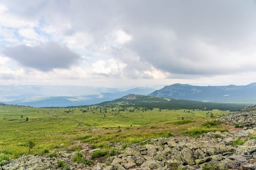 Forests and mountains of the Southern Urals near the village of Tyulyuk in Russia. Drone view