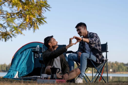 Happy Asian male gay couple on camping together in a forest. romantic vocation trip. lgbt concept.