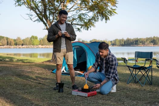 Happy Asian male gay couple on camping together in a forest. romantic vocation trip. lgbt concept.