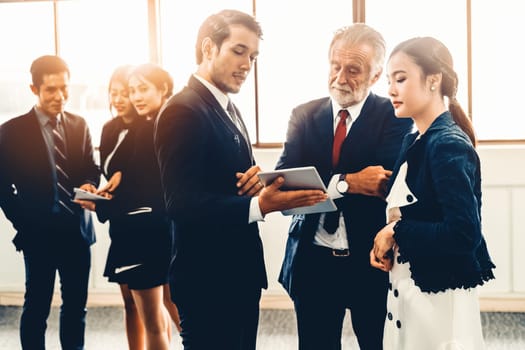 Many young businessmen and businesswomen in group meeting standing at conference hall in office. Multicultural company organization unity and support. Concept of partnership and human resources. uds