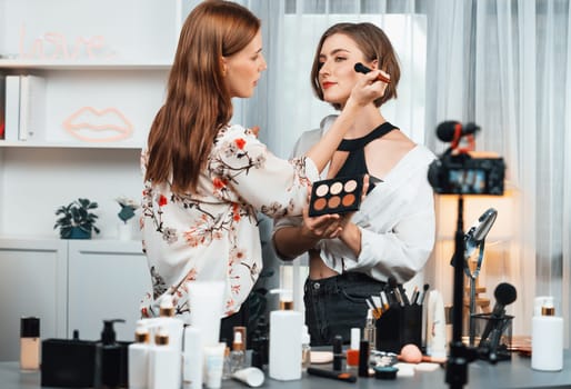 Woman influencer shoot live streaming vlog video review makeup utmost social media or blog. Happy young girl with cosmetics studio lighting for marketing recording session broadcasting online.