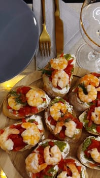 Festive candlelight dinner with shrimp and caviar sandwiches. High quality photo