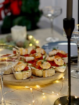 Festive candlelight dinner with shrimp and caviar sandwiches. High quality photo