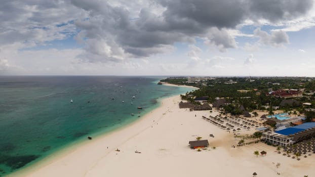 awesome aerial shot of shoreline and turquoise ocean in zanzibar at overcast day, tanzania.