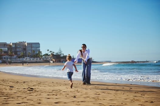 Affectionate mother playing with her little daughter on the beach. people. Lifestyle. Leisure activity. Family relationships