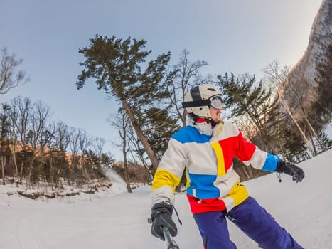 A daring man conquers snowy slopes with style, showcasing skill and thrill as he maneuvers on a snowboard, capturing the essence of winter adventure.