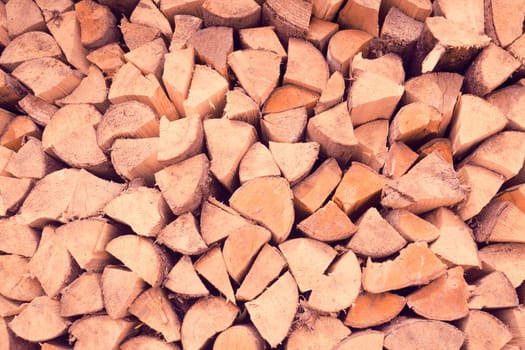 Old tree, logs, firewood harvested for the winter for the heating season, a beautiful background with textured wooden boards close-up.