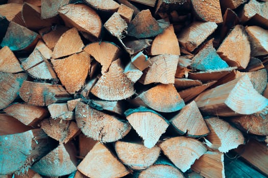 Old tree, logs, firewood harvested for the winter for the heating season, a beautiful background with textured wooden boards close-up.