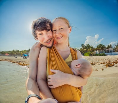 New parents cherish a beach day with their newborn a heartwarming family moment by the shore.