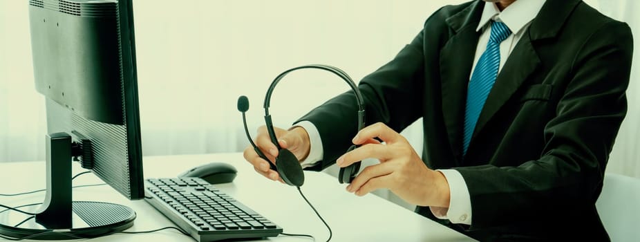 Business people wearing headset working in office to support remote customer or colleague. Call center, telemarketing, customer support agent provide service on telephone video conference oratory call