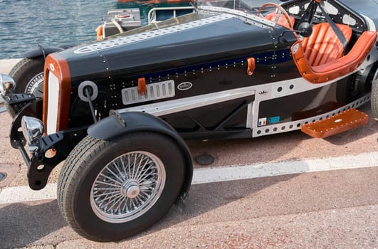 Monaco, Monte-Carlo, 29 September 2022: vintage open-top car at the yacht show on a sunny day, leather seats, spoked wheels, close-up. High quality photo