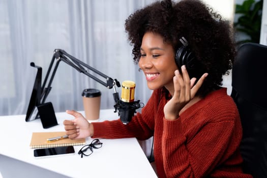 Host channel of beautiful African woman influencer talking with new listeners in broadcast studio. Time slot of life coach consultant on live social media online. Concept of giving advice. Tastemaker.