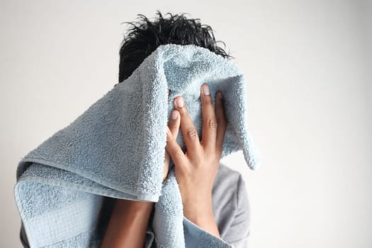 young Man drying his face