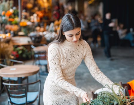 A young woman attends a masterclass to learn the art of crafting Christmas decorations. High quality photo