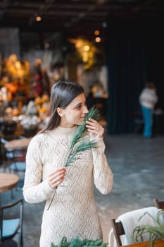 Actively participating in a crafting session, a young woman makes Christmas decorations. High quality photo