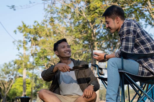 Happy Asian male gay couple on camping together in a forest. romantic vocation trip. lgbt concept.