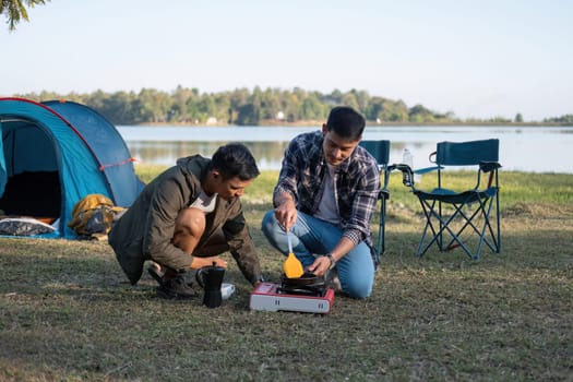 Happy Asian male gay couple on camping together in a forest. romantic vocation trip. lgbt concept.