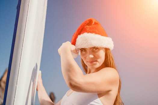 Close up shot of happy young caucasian woman looking at camera and smiling. Cute woman portrait in bikini posing on a volcanic rock high above the sea