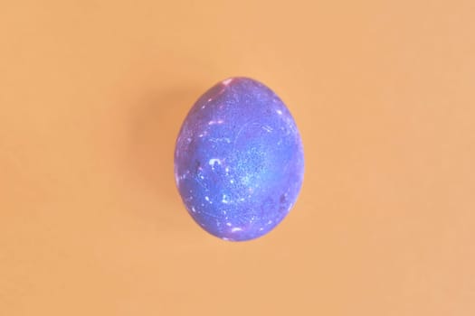 Cosmic galactic Easter egg on yellow pastel background