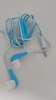 headphones with wire, background object,blue and white, inexpensive. High quality photo