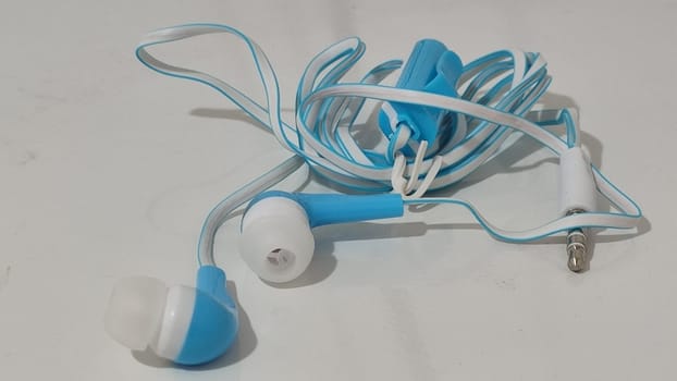 headphones with wire, background object,blue and white, inexpensive. High quality photo