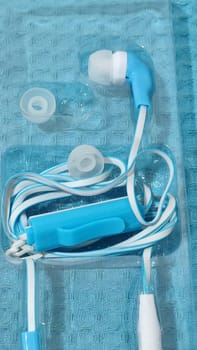 headphones with wire, background object,blue and white, inexpensive. High quality photo