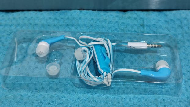 headphones with wire, background object,blue and white, inexpensive. High quality photo
