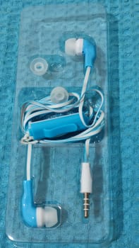 headphones with wire, background object,blue and white, inexpensive. High quality photo