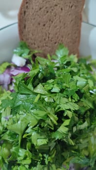 fresh green parsley salad, red onion, cheese, kitchen board, food, vegetarianism. High quality photo