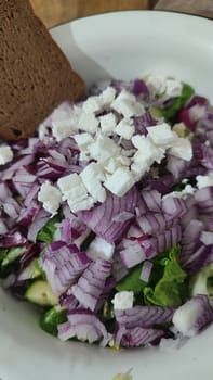 fresh green parsley salad, red onion, cheese, kitchen board, food, vegetarianism. High quality photo