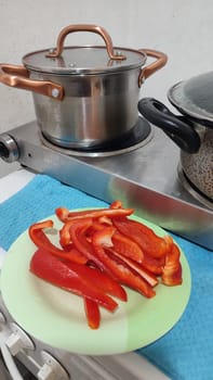 fresh cut red bell pepper, salad food pan in the kitchen vegetarianism. High quality photo