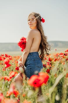 Woman poppies field. portrait of a happy woman with long hair in a poppy field and enjoying the beauty of nature in a warm summer day