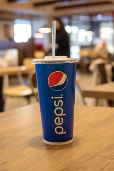 Belarus, Minsk - 24 march, 2023: A glass of Pepsi in a burger king