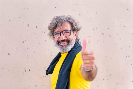 senior sports man with glasses smiling happy with with thumb up looking at camera, concept of active and healthy lifestyle on the middle age, copy space for text