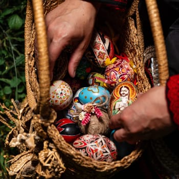 Ivano-Frankivsk, Ukraine August 14, 2023:Ukrainian Easter eggs in a wicker basket made of straw, Ukrainian art and traditions, eggs in a straw basket.