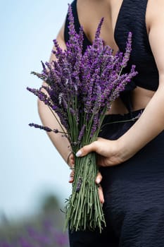 A girl with a fragrant lavender bouquet, aromatherapy on a lavender field.