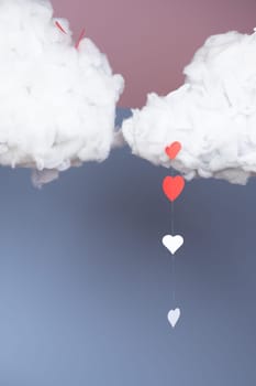 Decoration in a photo studio with clouds and hearts on a blue background.