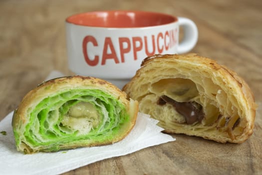 cappuccino with pistachio and chocolate croissant
