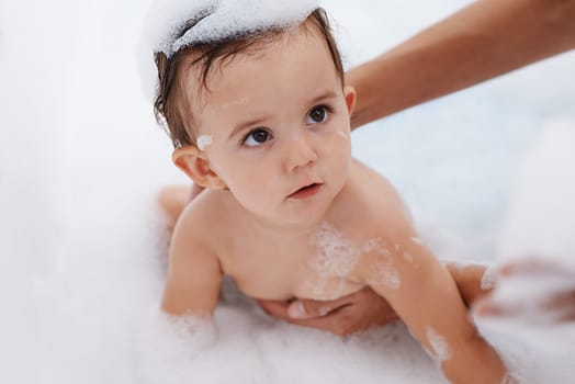 Baby, water and soap for washing in bathroom, bath and cleaning for skincare at home. Person, toddler and childcare or hygiene for prevention of bacteria and virus, cosmetics and liquid for care.