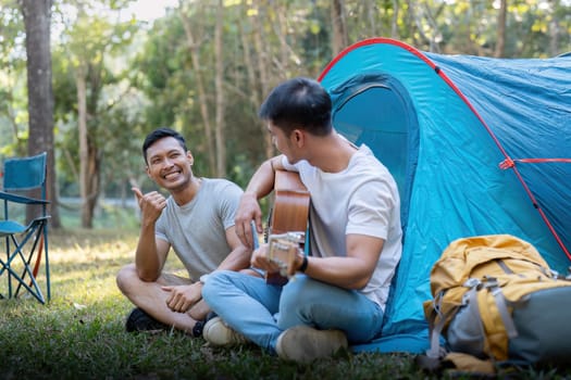 Male gay couple asian traveling with tent camping outdoor and various adventure lifestyle hiking active summer vacation.