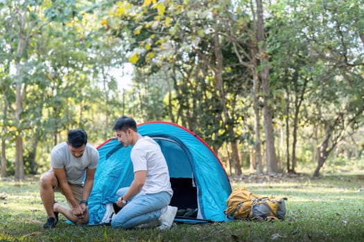 Male gay couple asian traveling with tent camping outdoor and various adventure lifestyle hiking active summer vacation.