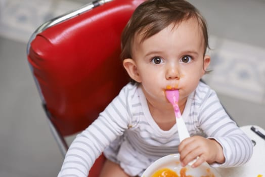 Eating, cute and portrait of baby in chair with vegetable food for child development at home. Sweet, nutrition and hungry boy kid or toddler enjoying healthy lunch, dinner or supper meal at house